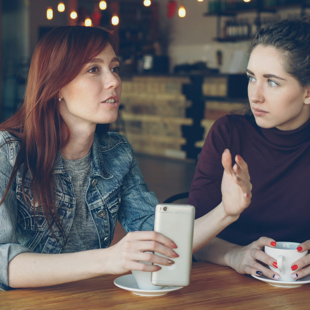 Two friends walking outside having an earnest discussion